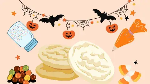 sugar cookies surrounded by Halloween decorations, sprinkles jar, candy, and icing