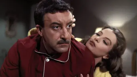 David Niven and Capuchine in character, pictured in pajamas 