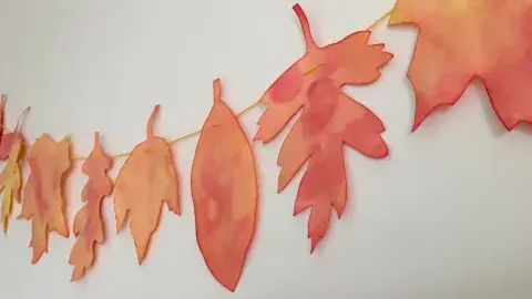 tie dyed coffee filter leaves on a garland