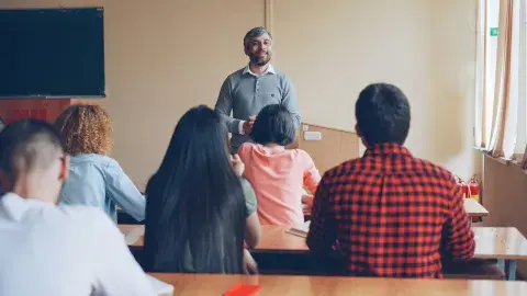Adults in a classroom doing a lesson