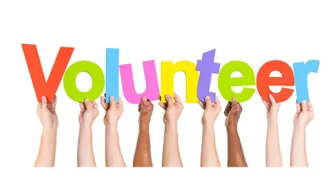 Hands each holding a word that spells out Volunteer.
