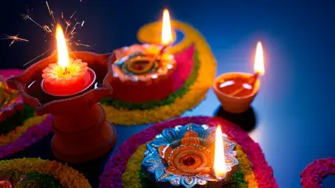 Celebrate Diwali with lighted candles in the colorful pots.