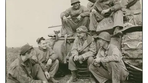 Ernie Pyle talks to tankers from the US Army's 191st Tank Battalion courtesy of the US Army Center for Military History.