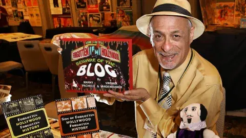 Manny Pacheco with his books