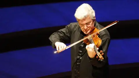 Paul Stein playing a violin