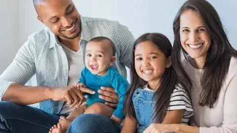 Man and woman sitting with two children
