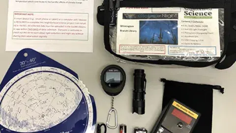 contents of a neighborhood science kit are lined up neatly on surface