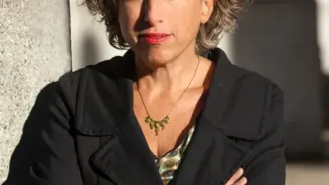Color headshot of Andrea Bernstein