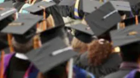 college graduation ceremony with all in black cap and gowns