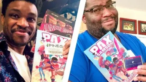 Authors Rashad Doucet and Jason Reeves holding up their book Pax Sampson