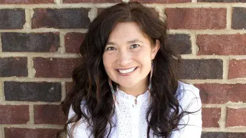 Felicia Zamora against a brick wall