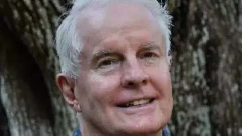 poet David Kirby in front of a tree
