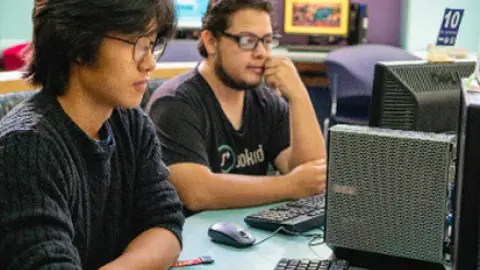 student with a laptop and headphones