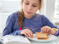 “Why, sometimes I've believed as many as six impossible things before breakfast.”―Lewis Carroll, Alice in Wonderland Girl reads a graphic novel while having a grilled ham and cheese sandwich