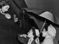 Herald-Examiner Collection | Los Angeles Public Library Young Japanese girls brave the early morning rain to bid farewell to friends leaving for Manzanar relocation camp