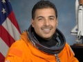 Astronaut Dr. Jose M. Hernandez in his orange spacesuit