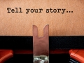 A paper in typewriter with the words "Tell your story".