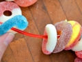 Candy loops being strung into a necklace