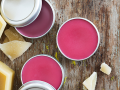 Tins of pink lip balm and beeswax tablets