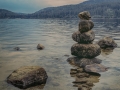 rocks stacked at the shore of a lake