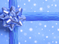 A present wrapped with blue snowflake patterned paper, ribbon, and bow.