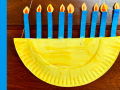 a paper plate menorah with blue paper candles