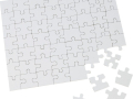 Unassembled white jigsaw puzzle pieces