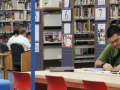 Two teens studying and reading in a designated Student Zone area.
