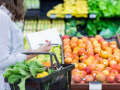 A woman shopping for vegetables in the produce section.