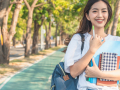 College student on campus with backpack and notebook