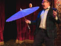 Michael Rayner juggles a cheeseburger on an umbrella