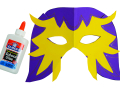 Lucha Libre mask made from purple and yellow construction paper shown with a bottle of Elmer's glue