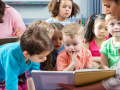 children listening to a story being read by a librarian