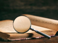 book with a magnifying glass