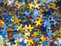 a pile of colorful jigsaw puzzle pieces