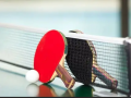 Two table tennis rackets and a ball on a table