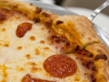 An up-close image of a pepperoni pizza