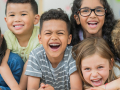 Six young children laughing.