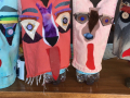 Four colorful dog puppets lined up in a row.