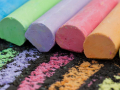 A row of coloring chalks marking the pavement. 