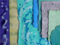 An assortment of handmade paper in different colors, shapes, and styles laid out on a flat surface. 