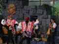 People dressed in Peruvian cultural clothes dancing and playing instruments. 
