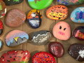 Various colors and designs on a set of painted rocks