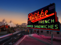 neon Philippes French Dip sign over a sunset