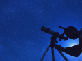 Astronomer looking through telescope observing the night sky