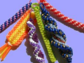 A display of six braided colorful lanyards.