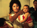 Sophia Loren is holding a child 