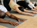 people in a line on mats in child pose