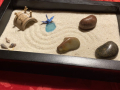 a mini Zen garden with a box with sand and rocks
