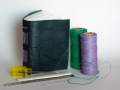 homemade book with thread spools